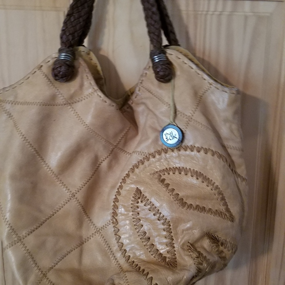 The Sak tan leather/braided leather handles
